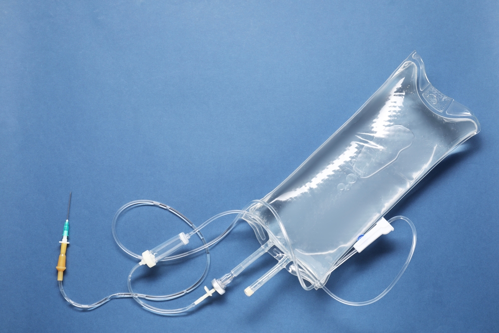 Iv,infusion,set,on,blue,background,,top,view.,space,for