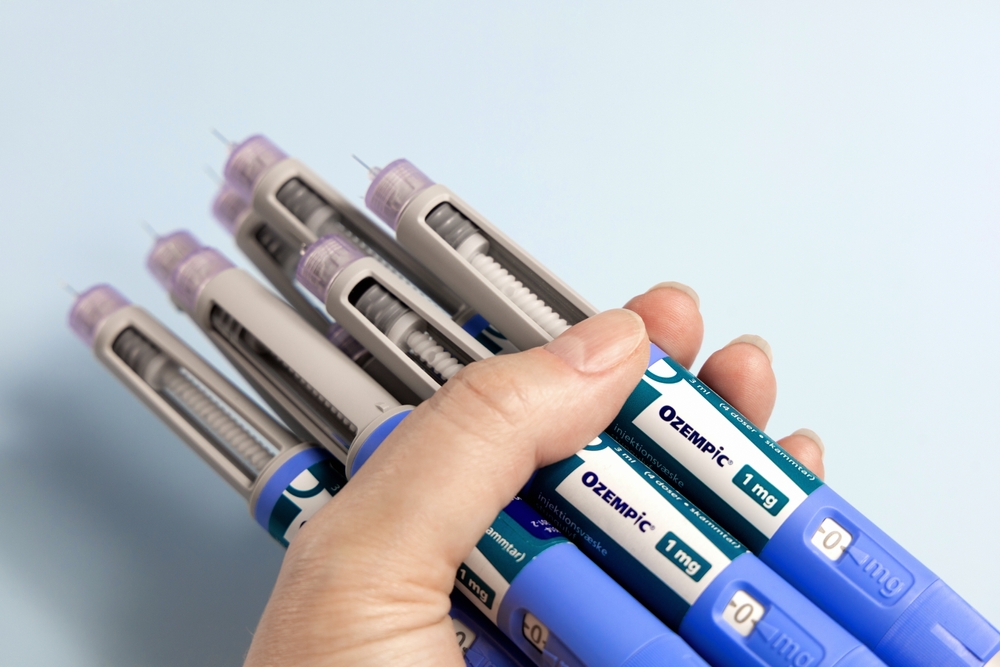 A,woman's,hands,holds,many,ozempic,syringe,pen,with,needle.