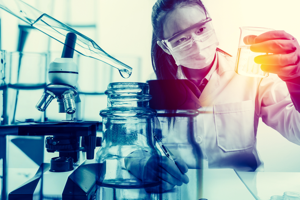 Scientist,holding,flask,with,lab,glassware,in,chemical,laboratory,background,