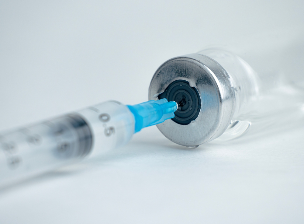 A,syringe,is,inserted,into,a,vial